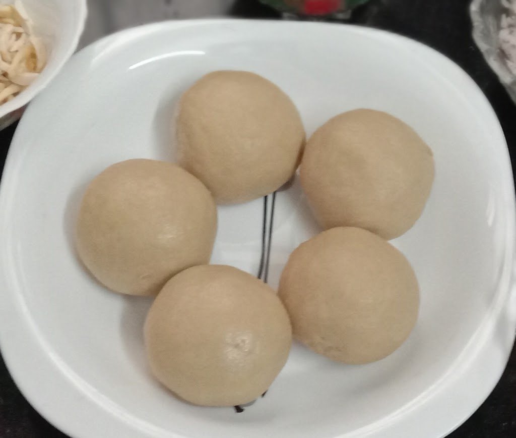 Dough balls in bowl, Malida and Malida ladoos.