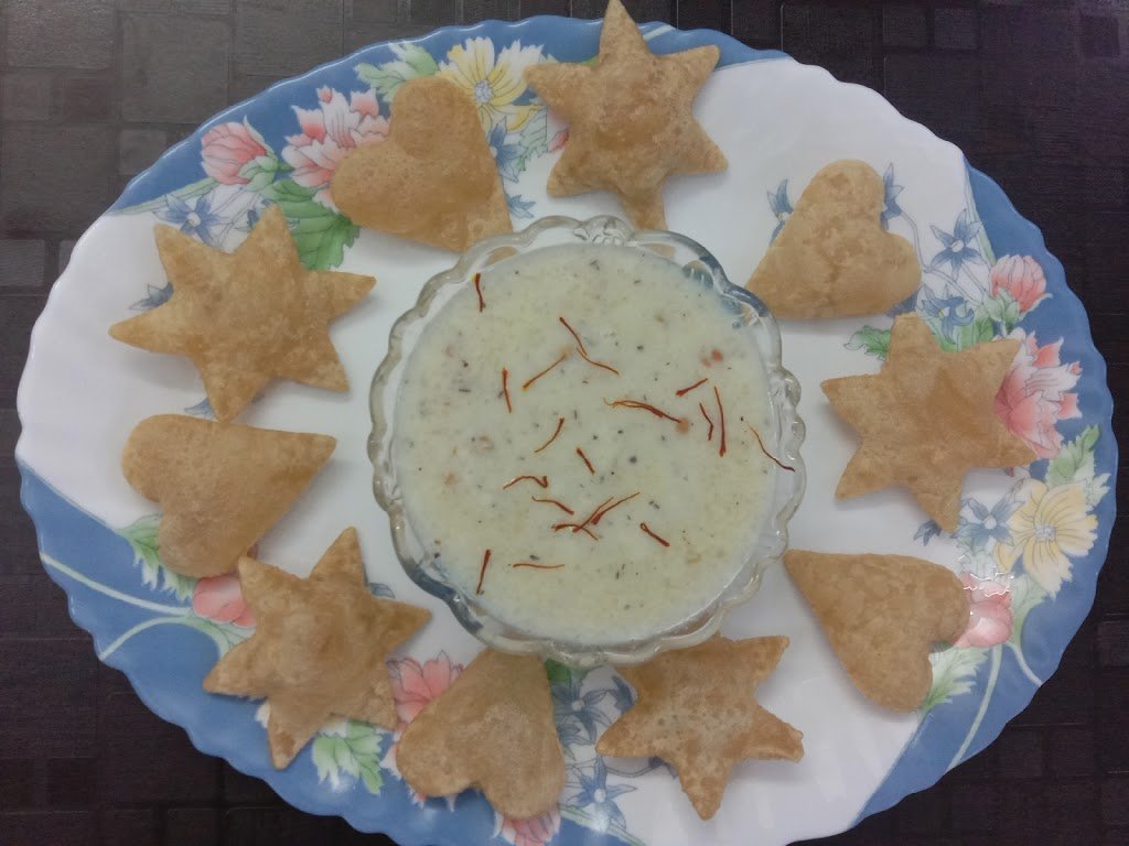 Rice kheer in bowl with puries, Rice kheer recipe.