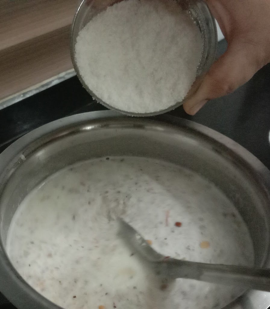 Adding ground rice in milk, rice kheer recipe.