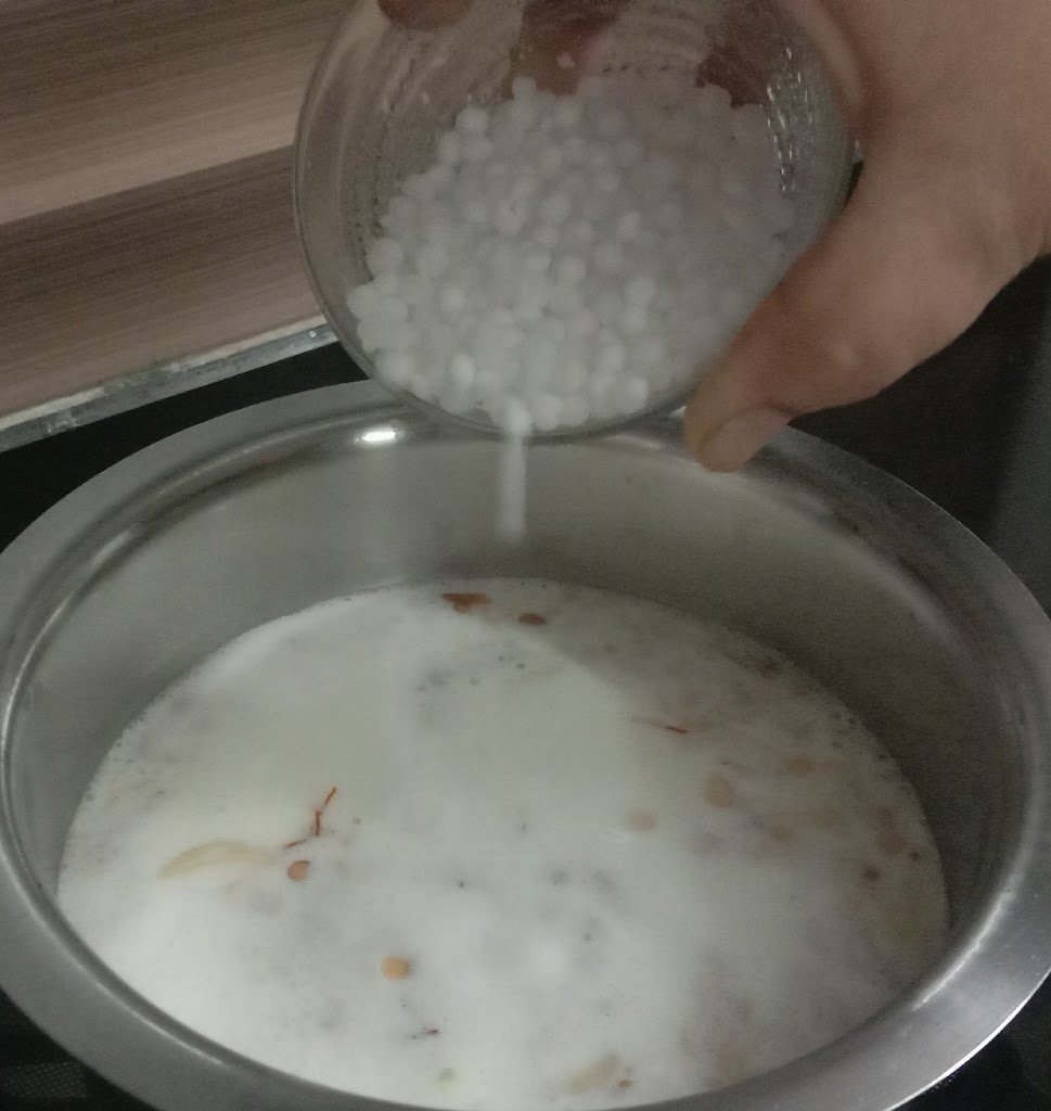 Adding sago in milk, rice kheer recipe.