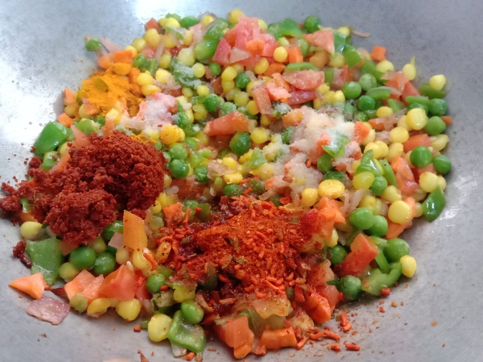 Adding chilli powder and masala in pot, Egg bhurji maggi noodles recipe.