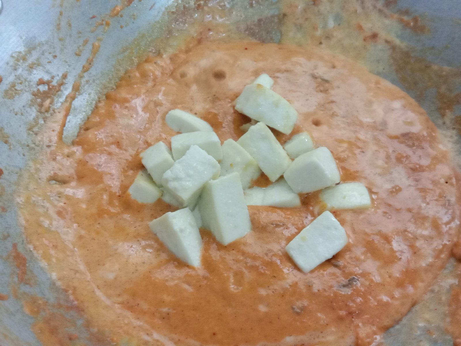 Adding paneer cubes to puree, butter paneer recipe.