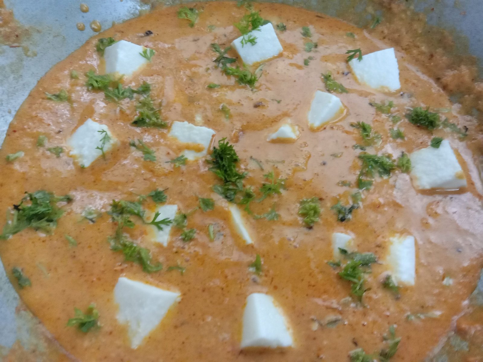 Adding coriander leaves to butter paneer, Butter paneer recipe.