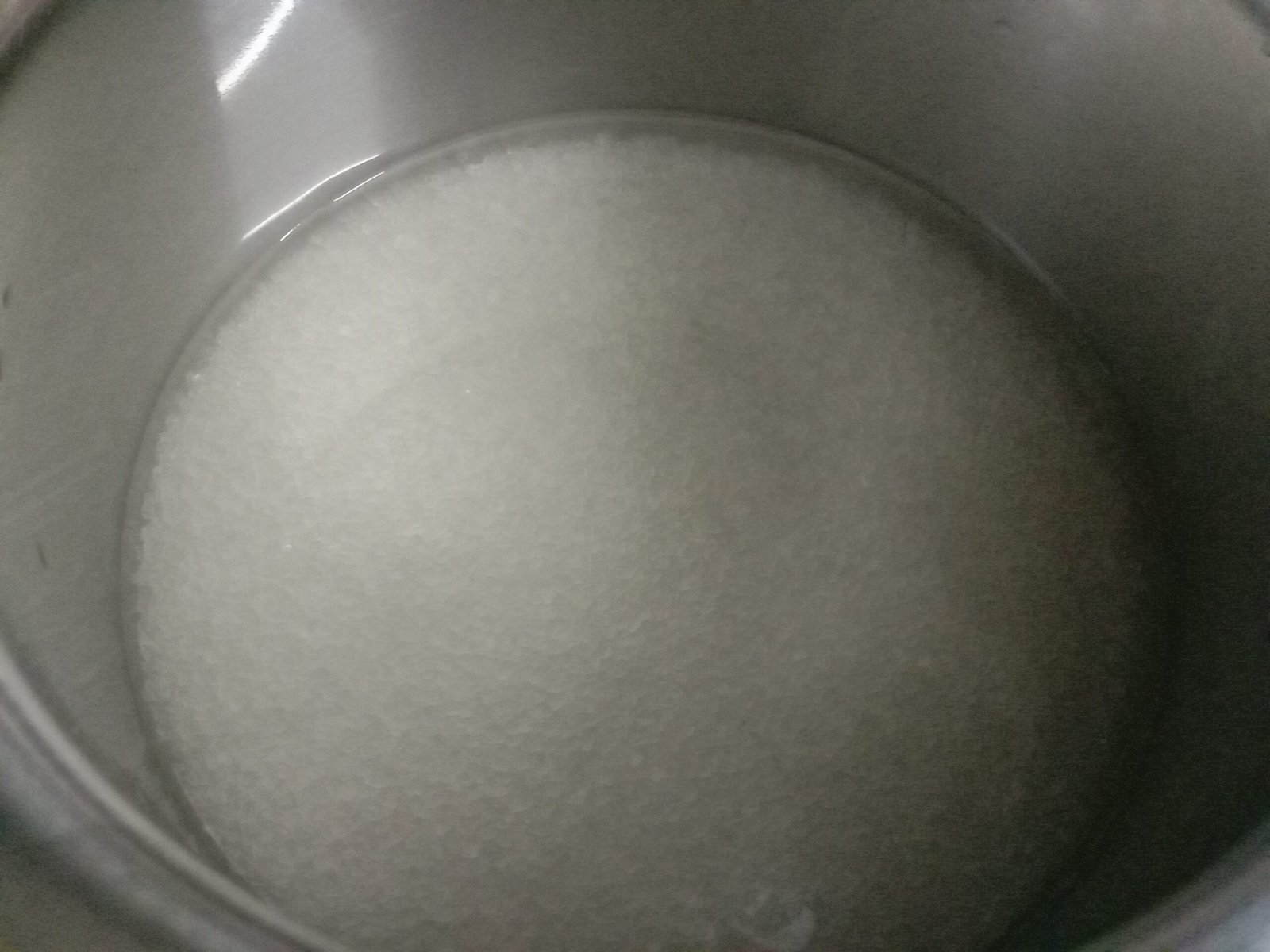Adding water and sugar in pot for sugar syrup, gulab jamun recipe.