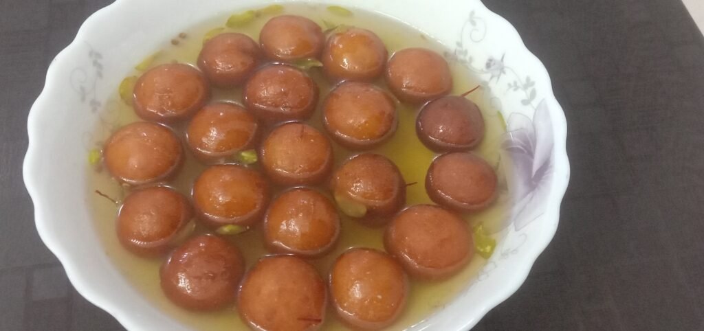 Dipping balls in syrup, Gulab jamun recipe.Gulab jamun in syrup, Gulab jamun recipe.