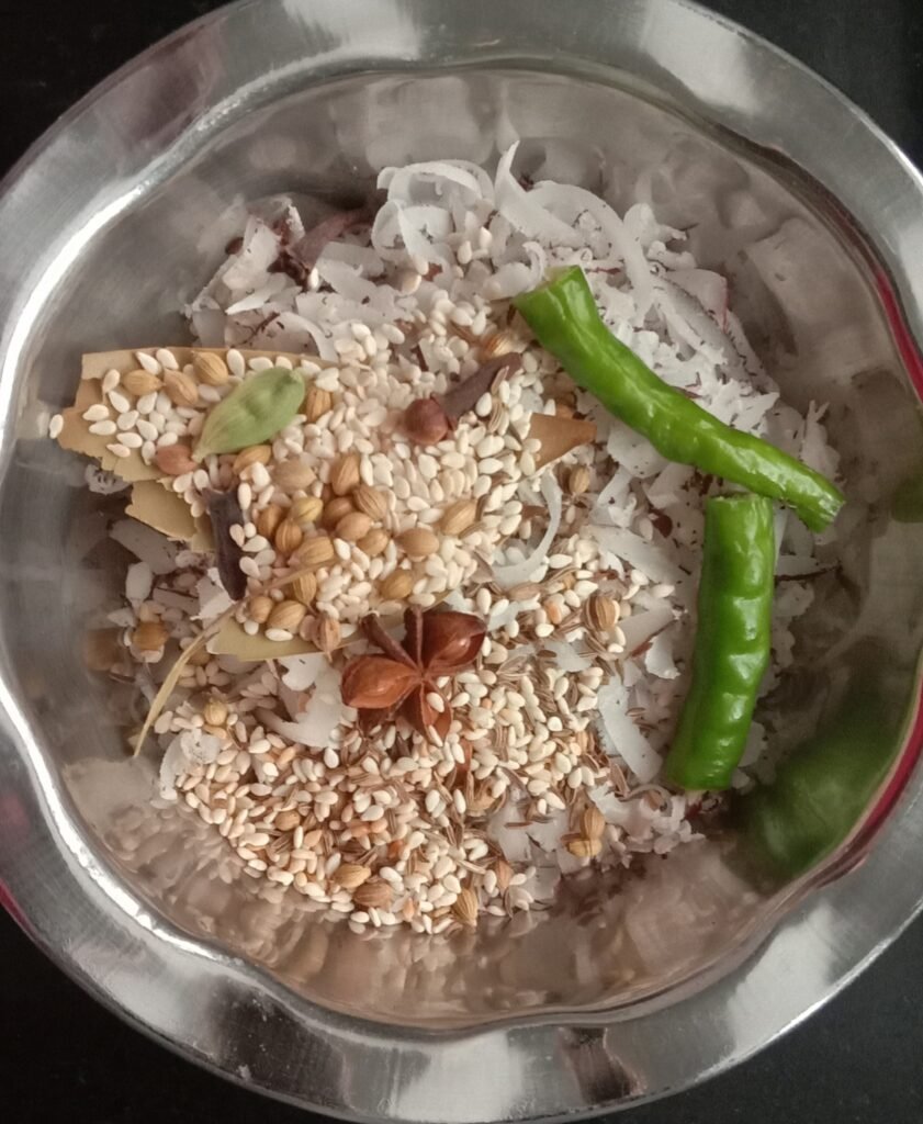Mixing ingredients in bowl, Kolhapuri chicken curry recipe.