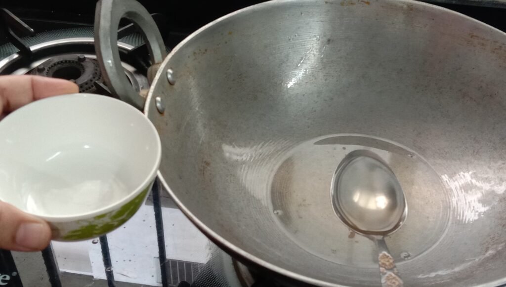 Remove oil from kadhai, Poha recipe.