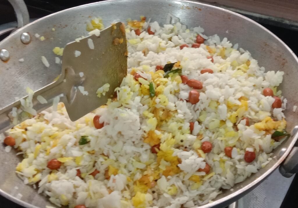 Mixing spices and poha, Poha recipe.
