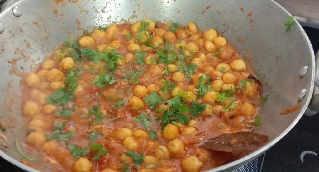 Adding chopped coriander, Chole bhature recipe.