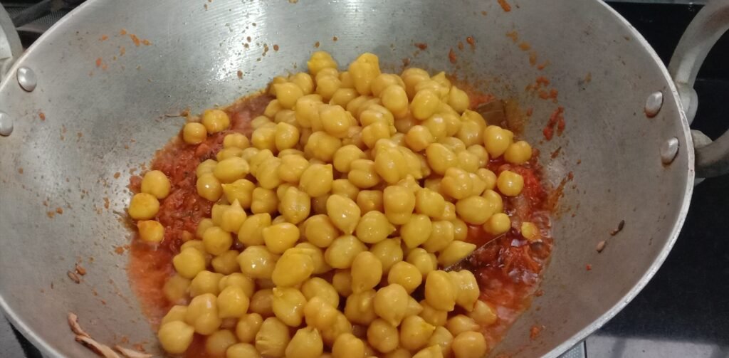 Adding boiled chana in masala, Chole bhature masala.