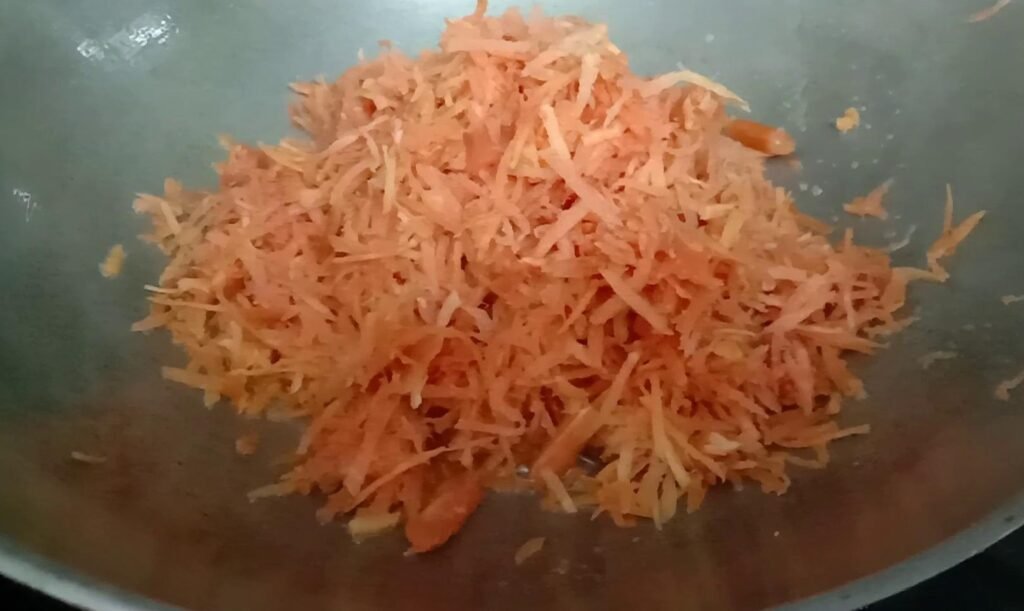 Add grated carrots to kadhai, Gajar ka halwa recipe.