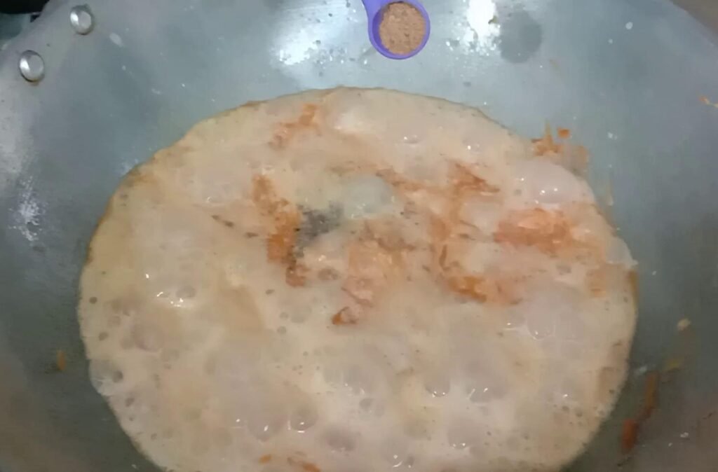 Adding nutmeg powder to halwa, Gajar ka halwa recipe.