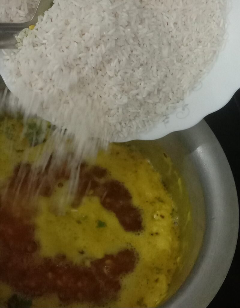 Adding rice to khichdi, Moong dal khichdi recipe.