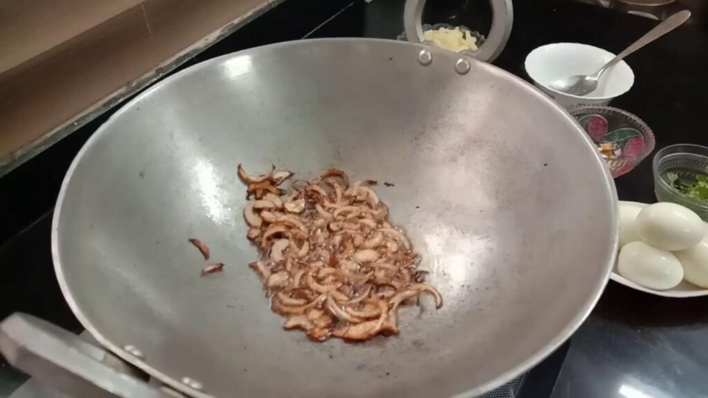 Frying the onion in kadhai, Egg masala recipe.