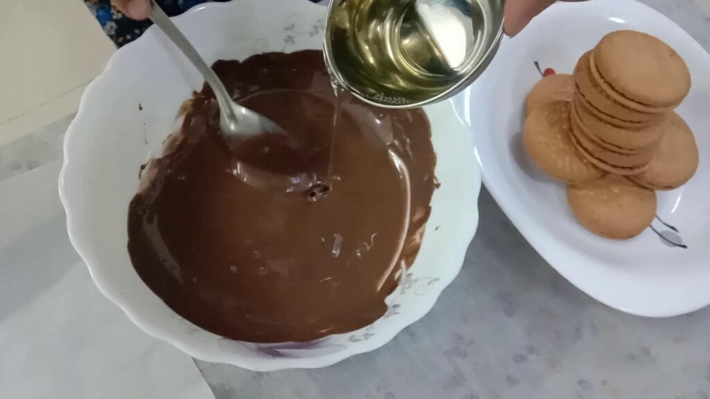Adding coconut oil to melted chocolate, Chocolate dipped cookies.