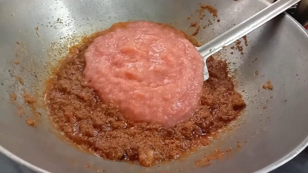 Adding Ginger garlic and tomato paste to kadhai, Chicken biryani.