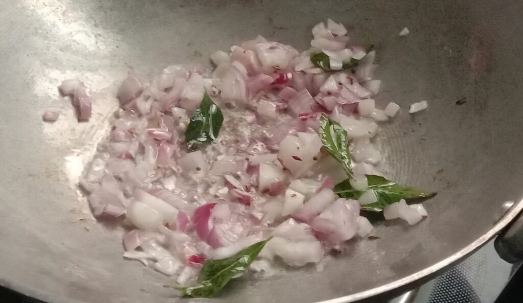 Frying onions in kadhai, Okra recipe.