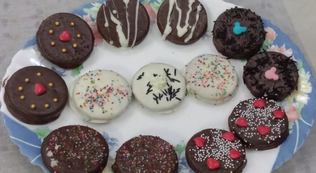 Decorated cookies in plate, Chocolate dipped cookies.