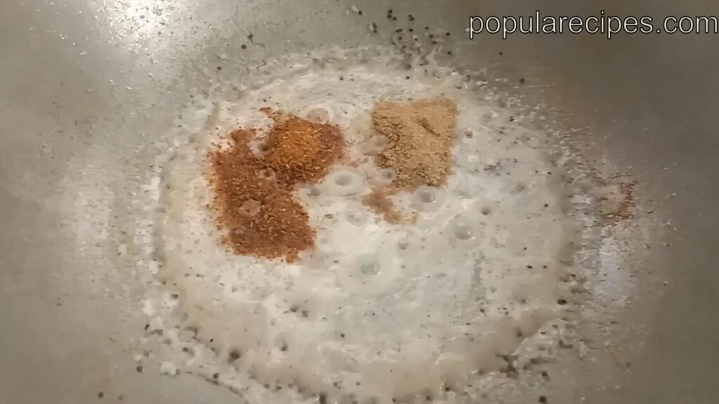 Frying spices in pan, Chicken biryani recipe.