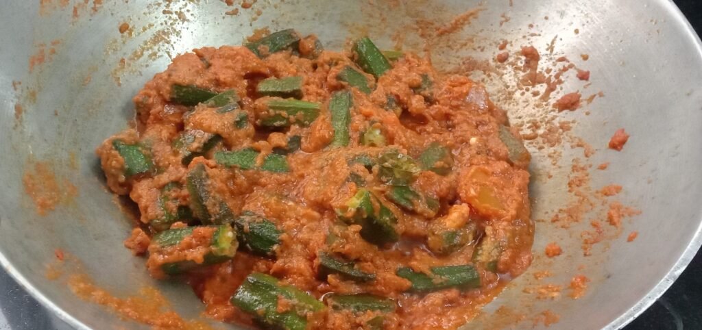 Mixing bhindi with masala, Bhindi masala recipe.