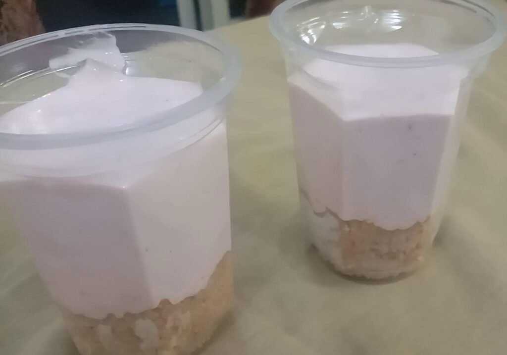 Pouring cream on biscuit crumbs, Strawberry mousse recipe. 