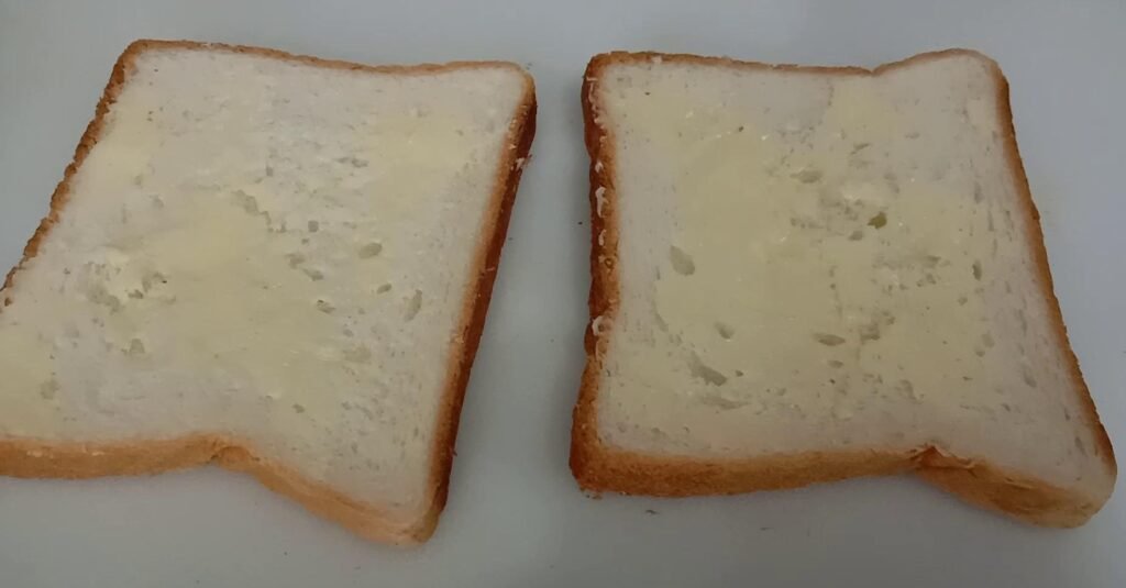 Spreading butter on bread, Chilli cheese toast.