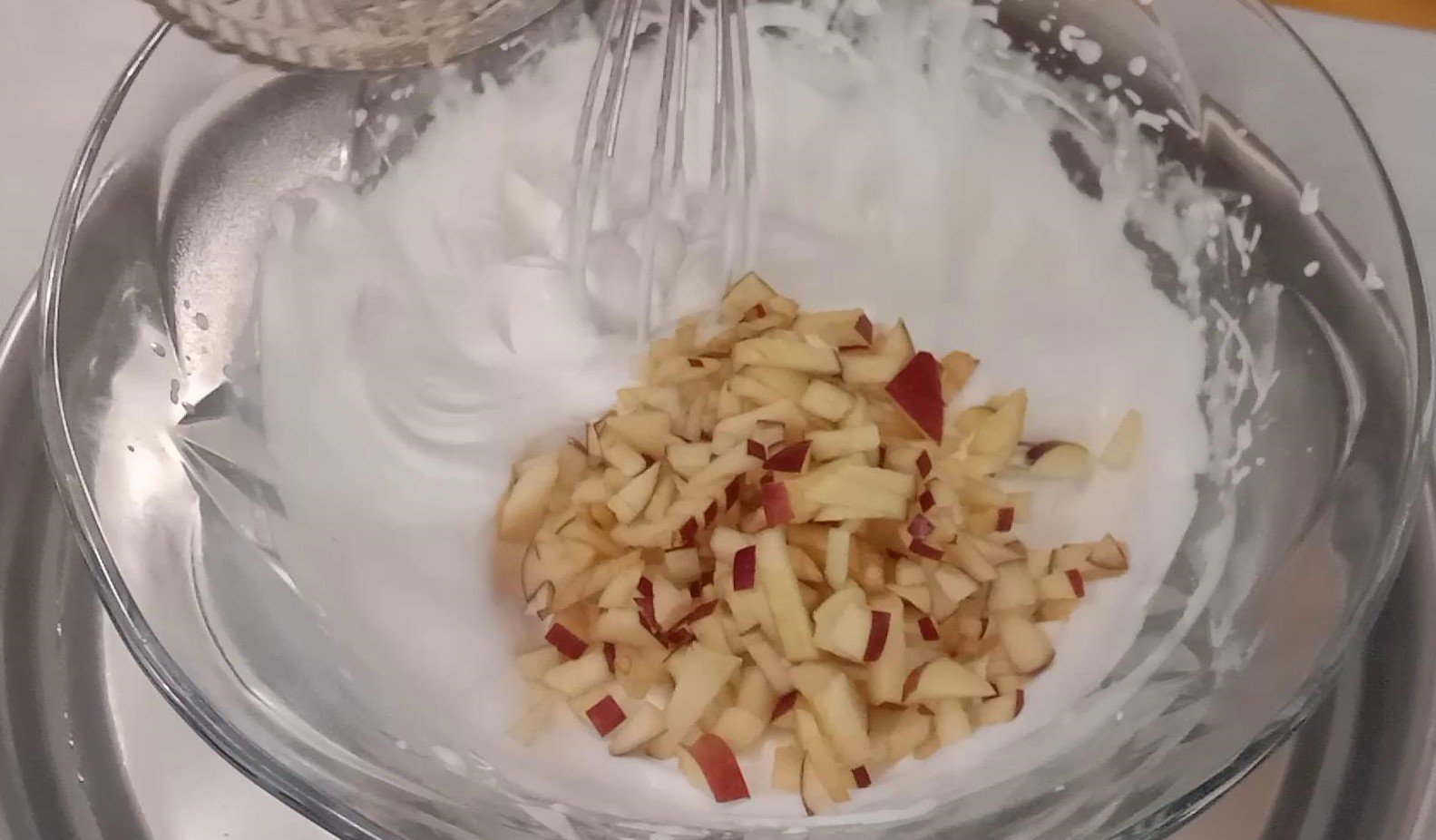 Adding chopped apple to cream, Choco Dessert.