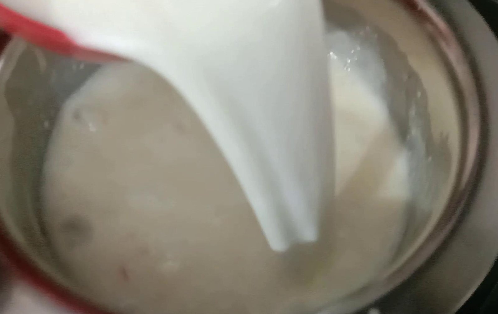 Adding milk to cream, Matka Malai Kulfi.