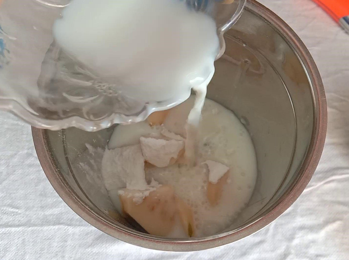 Adding guava pieces, powdered sugar and milk to mAdding guava pieces, powdered sugar and milk to mixer jar, Guava Smoothie.
