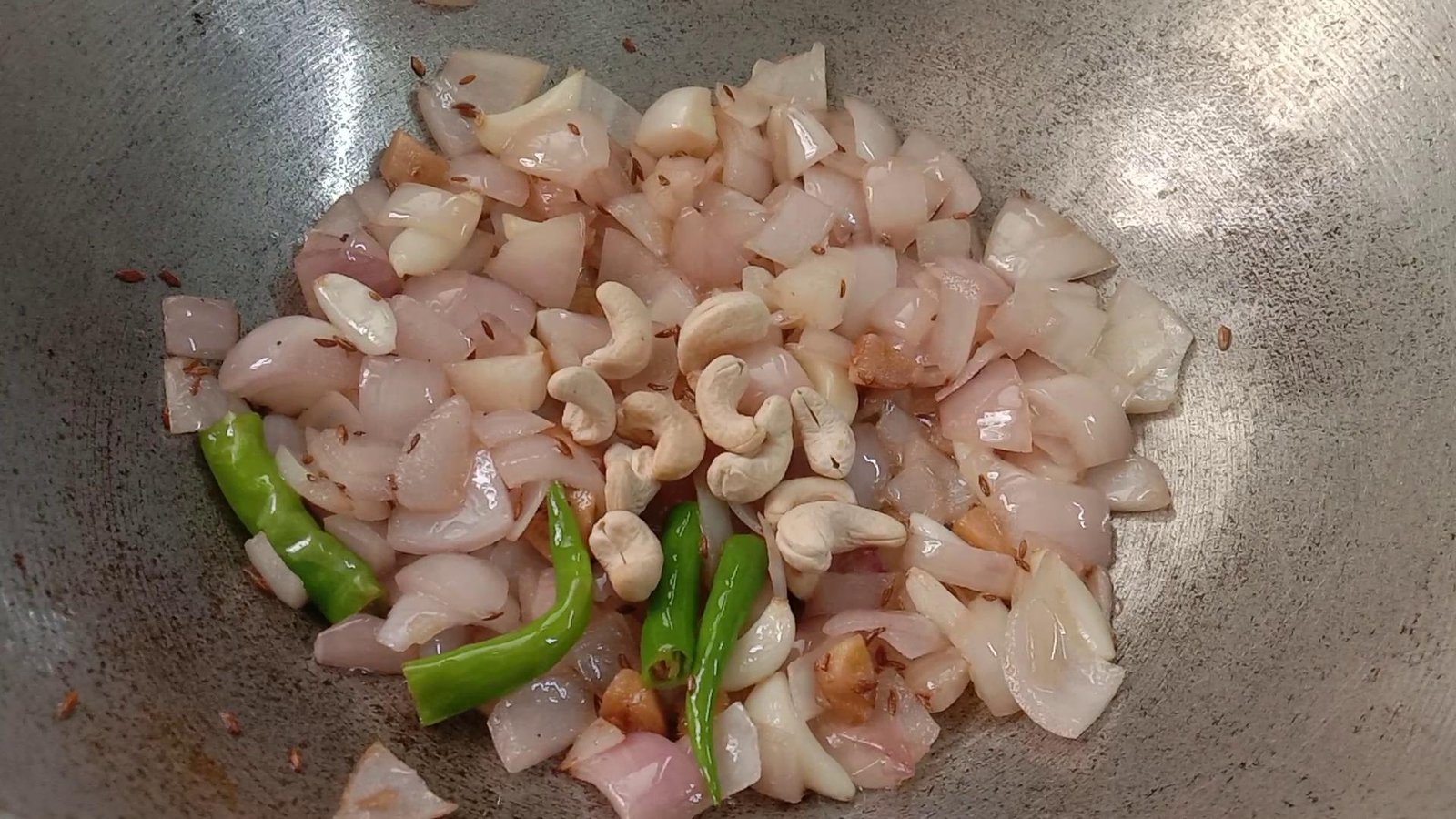 Adding cashew nuts to kadhai, Palak paneer-Spinach Paneer
