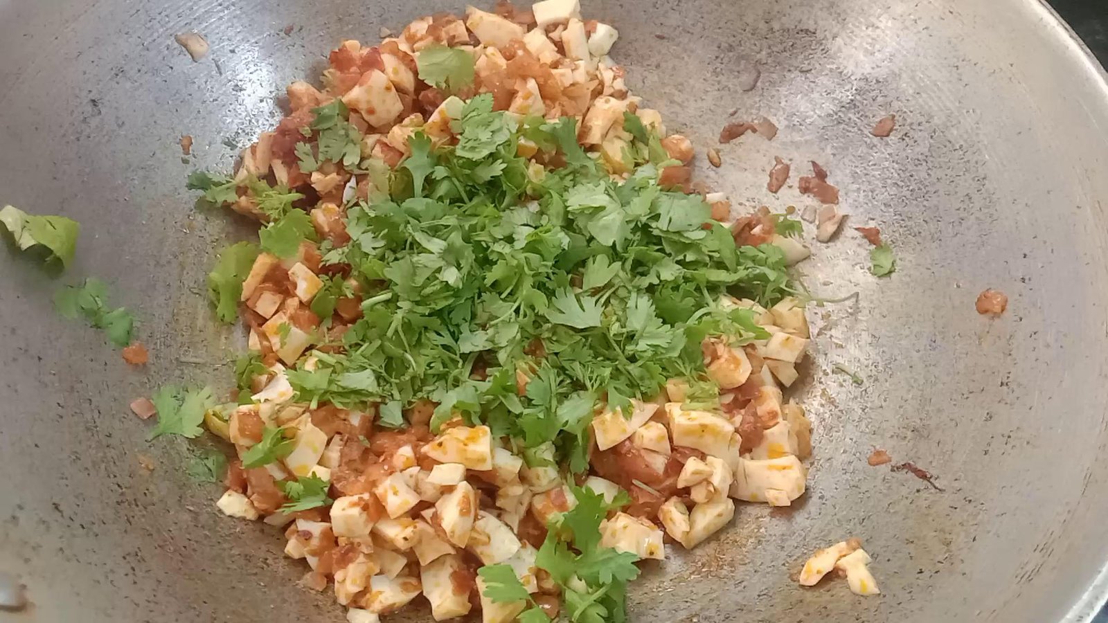 Adding chopped coriander leaves, Egg paratha | Anda paratha recipe.